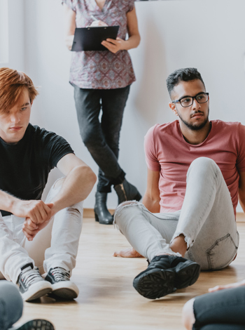 students sitting in a circle in a workshop